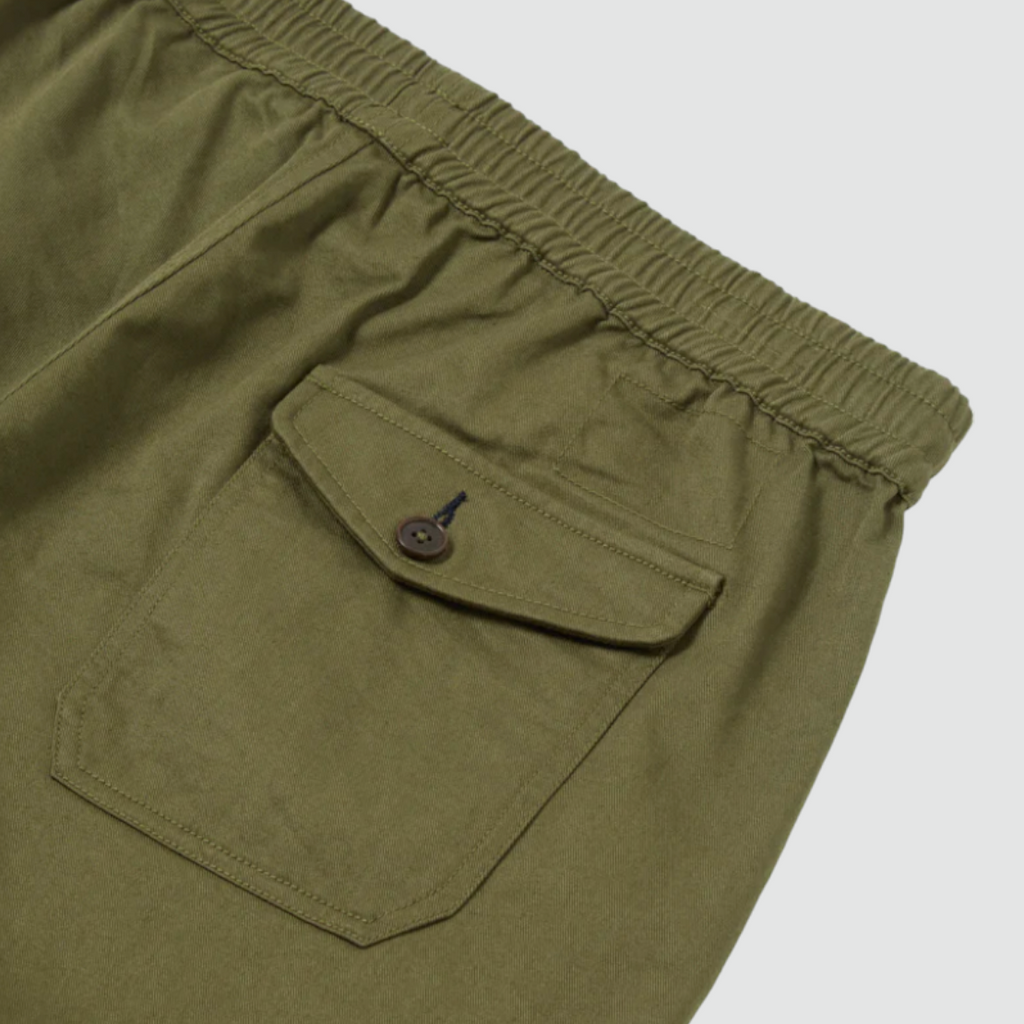 Universal Works Beach Short in Light Olive Twill - Comfortable above-the-knee short with elasticated drawstring waist. Crafted from exclusive UW fabric in 3/1 twill weave