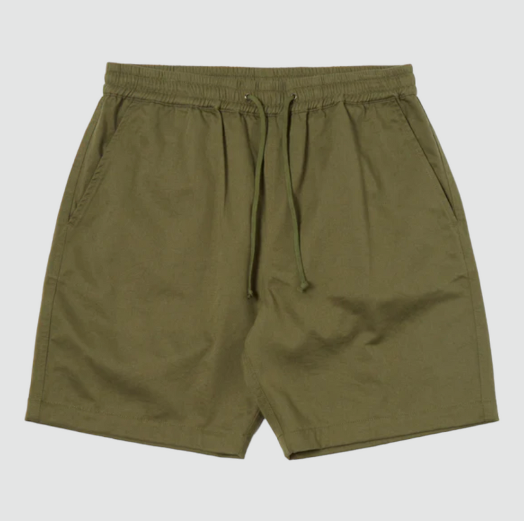 Universal Works Beach Short in Light Olive Twill - Comfortable above-the-knee short with elasticated drawstring waist. Crafted from exclusive UW fabric in 3/1 twill weave