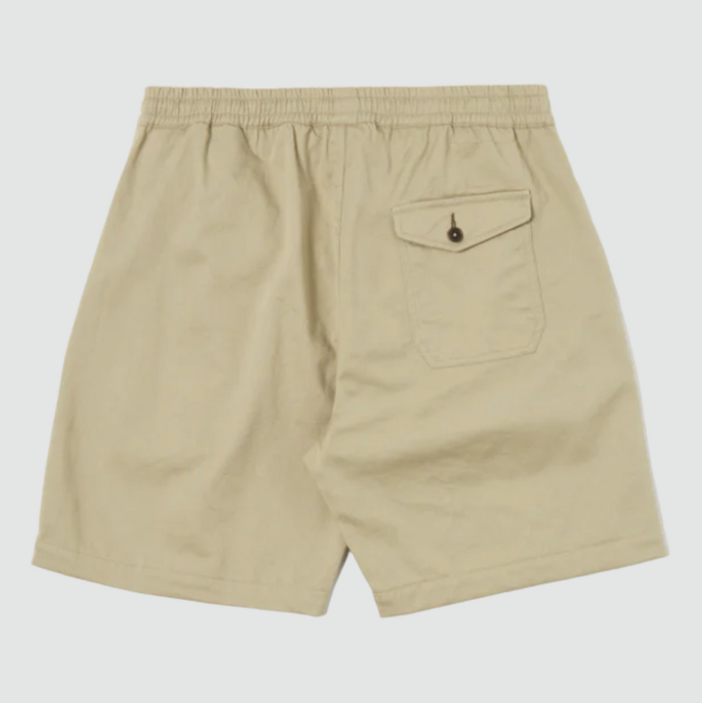 Universal Works Beach Short in Stone Twill - Comfortable above-the-knee short with elasticated drawstring waist. Crafted from exclusive UW fabric in 3/1 twill weave