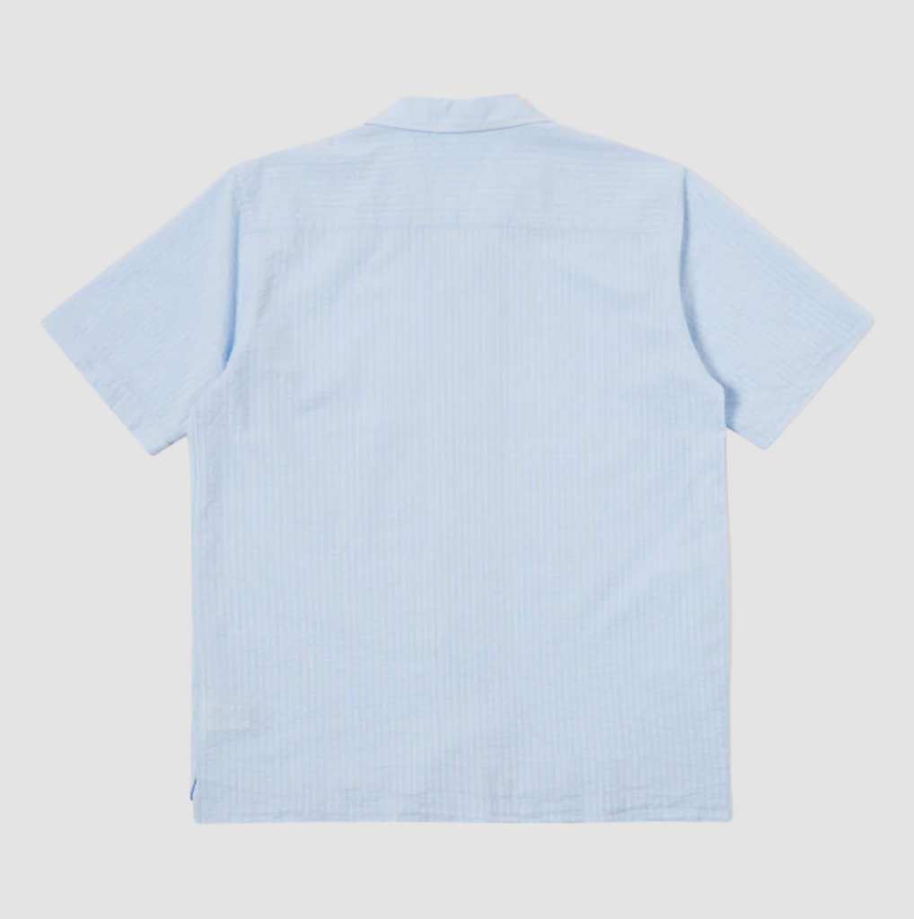 Universal Works Camp Shirt II in Pale Blue Onda Cotton: Relaxed fit shirt with modern design, crafted from lightweight, garment-dyed cotton. Perfect for summer with its comfortable feel and stylish details