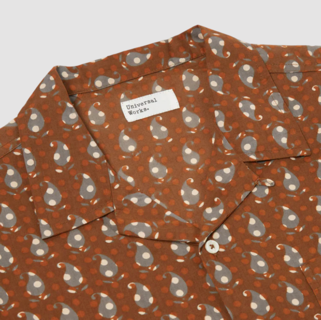 Universal Works Road Shirt in Brown Paisley Block Print: Classic short-sleeved summer shirt with relaxed fit, crafted from fine cambric cotton. Features intricate hand-blocked paisley design, perfect for casual or formal wear