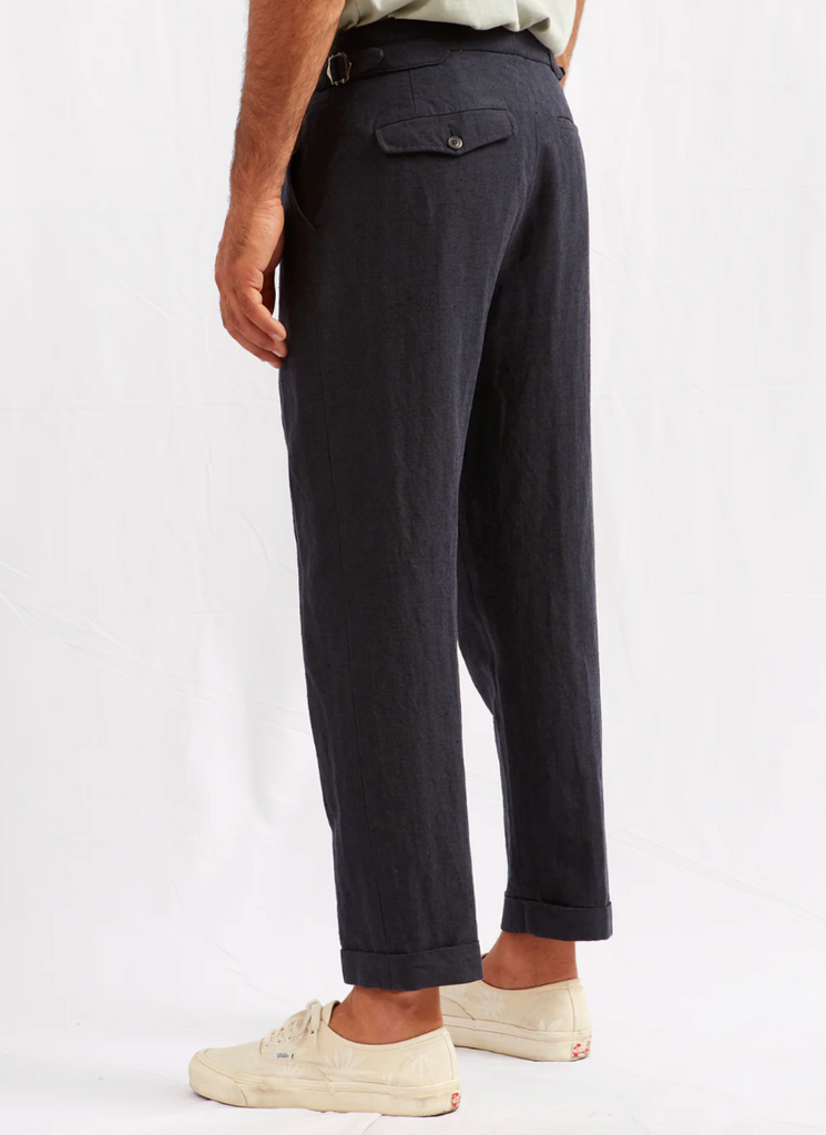 ABCL Garments Alvise Hemp Cotton Herringbone Trouser in Navy, featuring a tailored fit, flap pocket, cropped leg, adjustable waist, and real horn buttons.