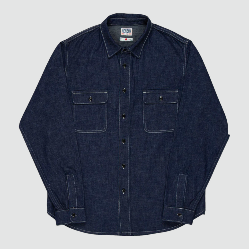 A regular-fit work shirt made from 8 oz. Japanese denim, featuring two chest flap pockets, black overdyed corozo buttons, and heavy-duty stitching.