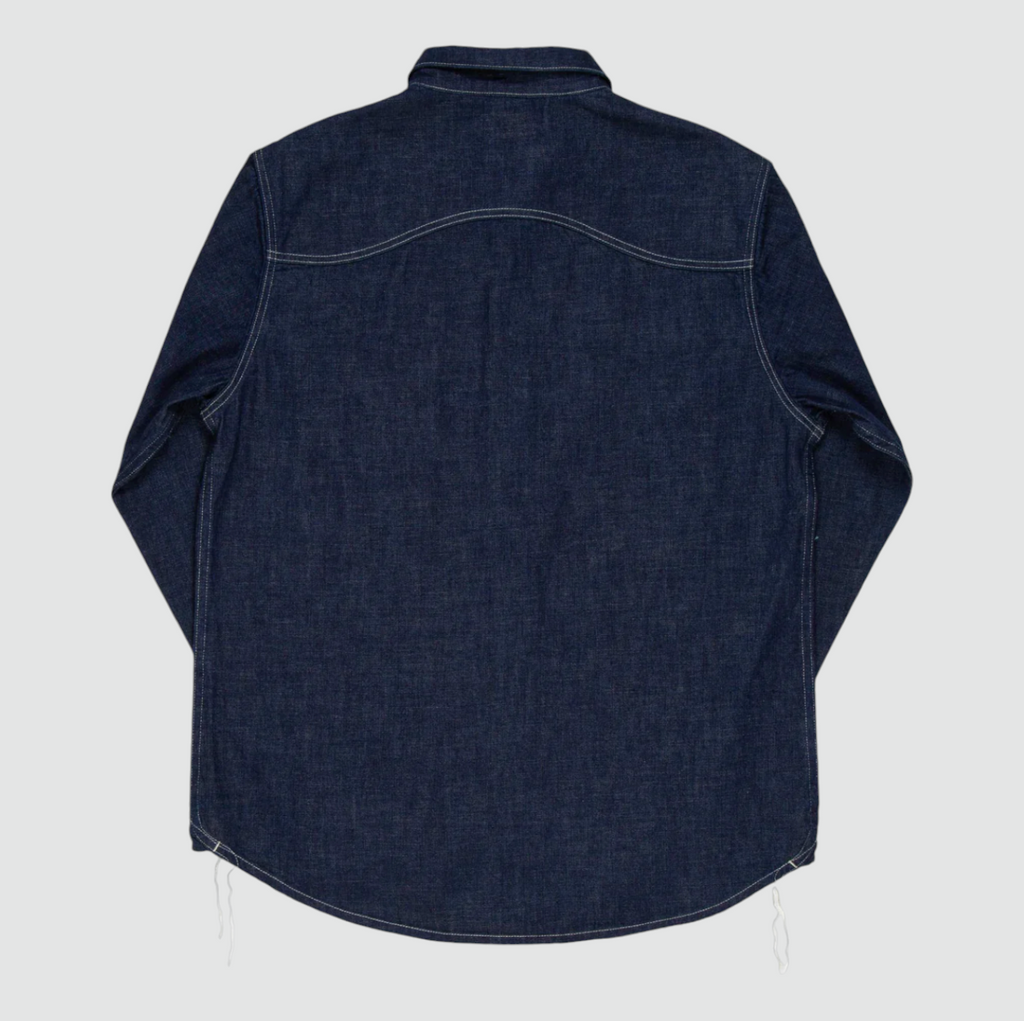 A regular-fit work shirt made from 8 oz. Japanese denim, featuring two chest flap pockets, black overdyed corozo buttons, and heavy-duty stitching.