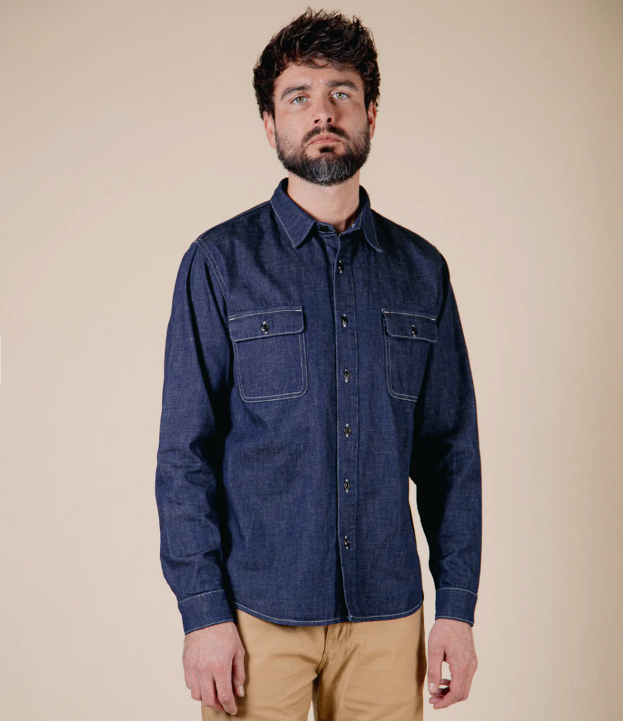 A regular-fit work shirt made from 8 oz. Japanese denim, featuring two chest flap pockets, black overdyed corozo buttons, and heavy-duty stitching.
