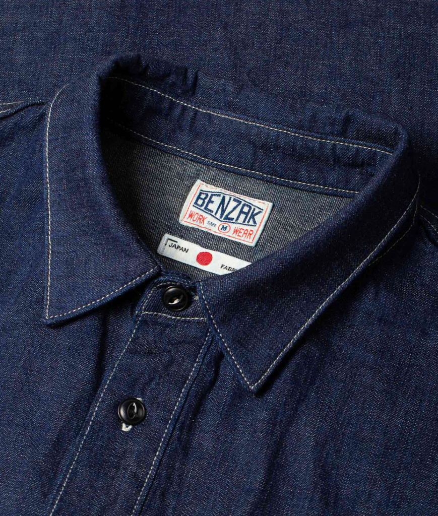 A regular-fit work shirt made from 8 oz. Japanese denim, featuring two chest flap pockets, black overdyed corozo buttons, and heavy-duty stitching.