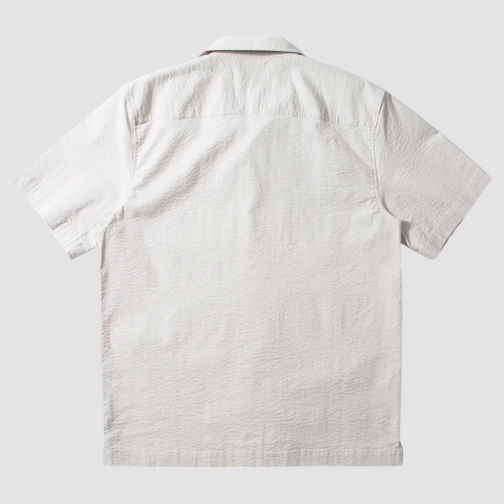 Short sleeve grey seersucker shirt featuring a chest pocket, button front, and relaxed fit with subtle stretch for comfort.