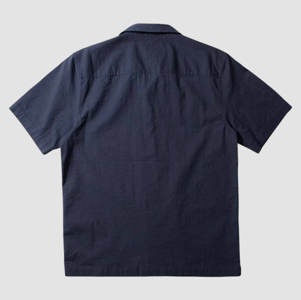 Navy seersucker short sleeve shirt with chest pocket, button front, and relaxed fit, made from cotton with a touch of stretch.