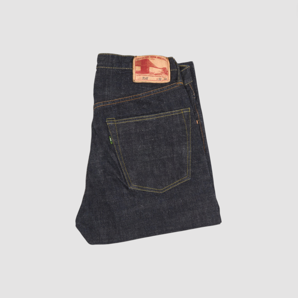 Japanese selvedge denim jeans on a light grey background.
