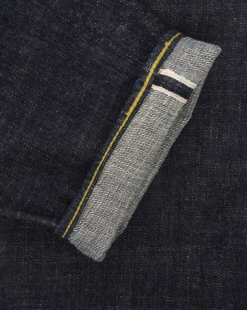 Japanese selvedge denim jeans on a light grey background.
