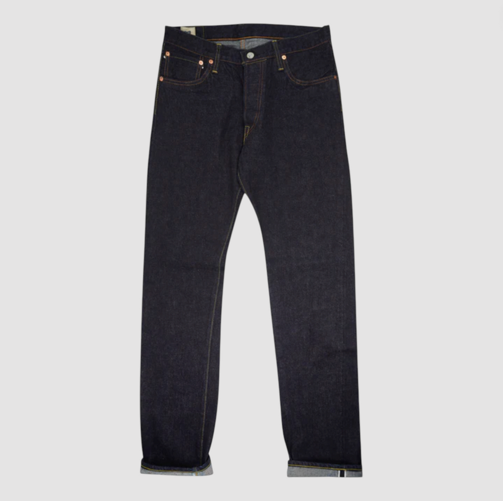 A pair of Japanese selvedge denim jeans on a light grey background.