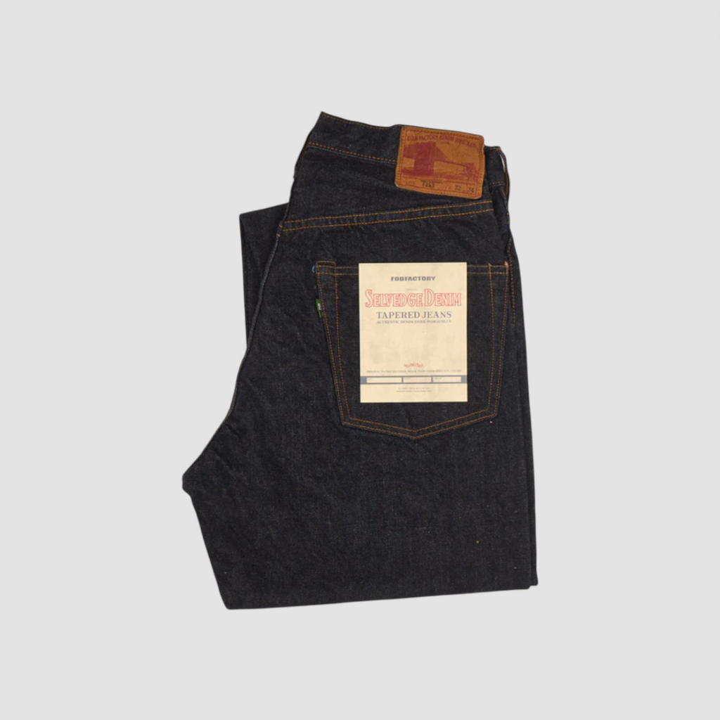 Japanese selvedge denim jeans on a light grey background.