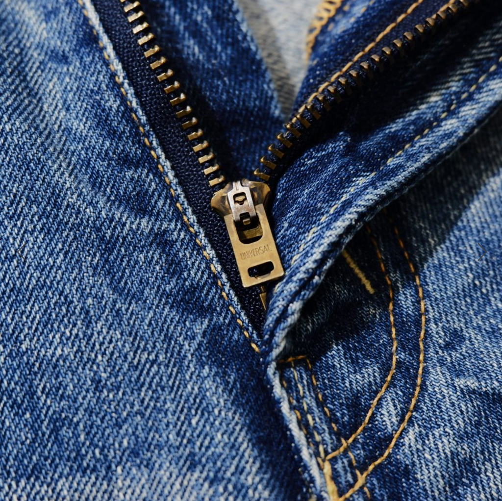 Selvedge denim jeans with a tapered 66 model fit, featuring a vintage-inspired texture, rich indigo fade, and classic workwear heritage.