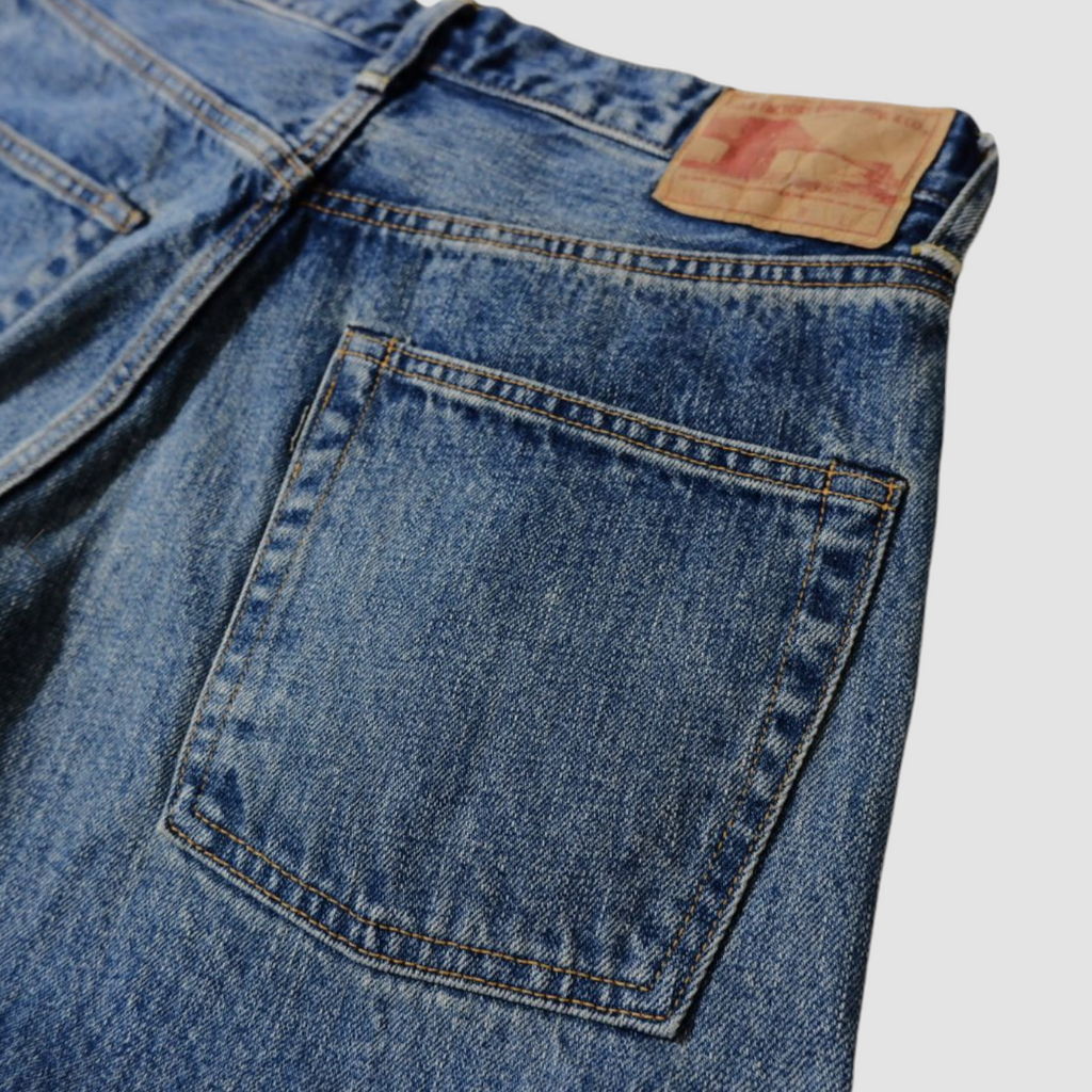Selvedge denim jeans with a tapered 66 model fit, featuring a vintage-inspired texture, rich indigo fade, and classic workwear heritage.