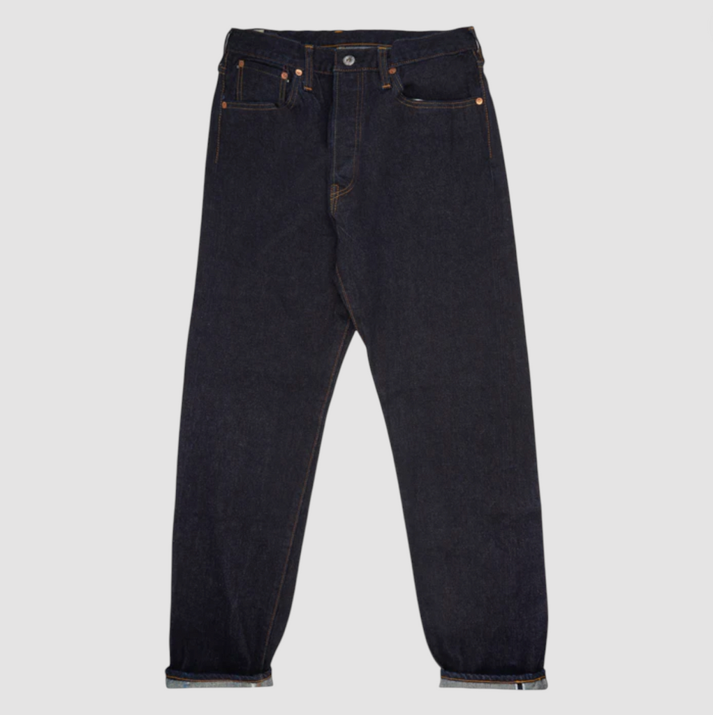 A pair of Japanese selvedge denim jeans on a light grey background.