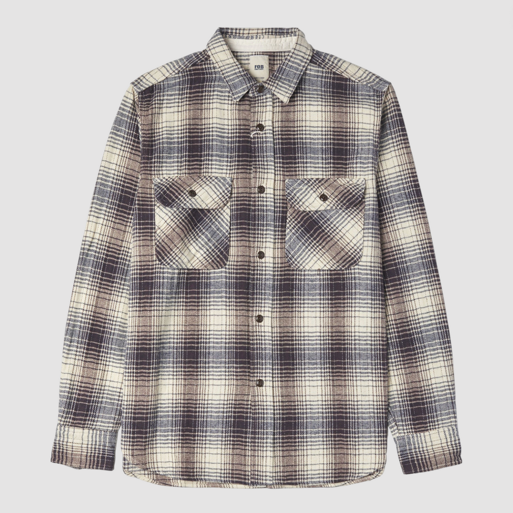 Navy and ecru checkered shirt on a light grey background. 