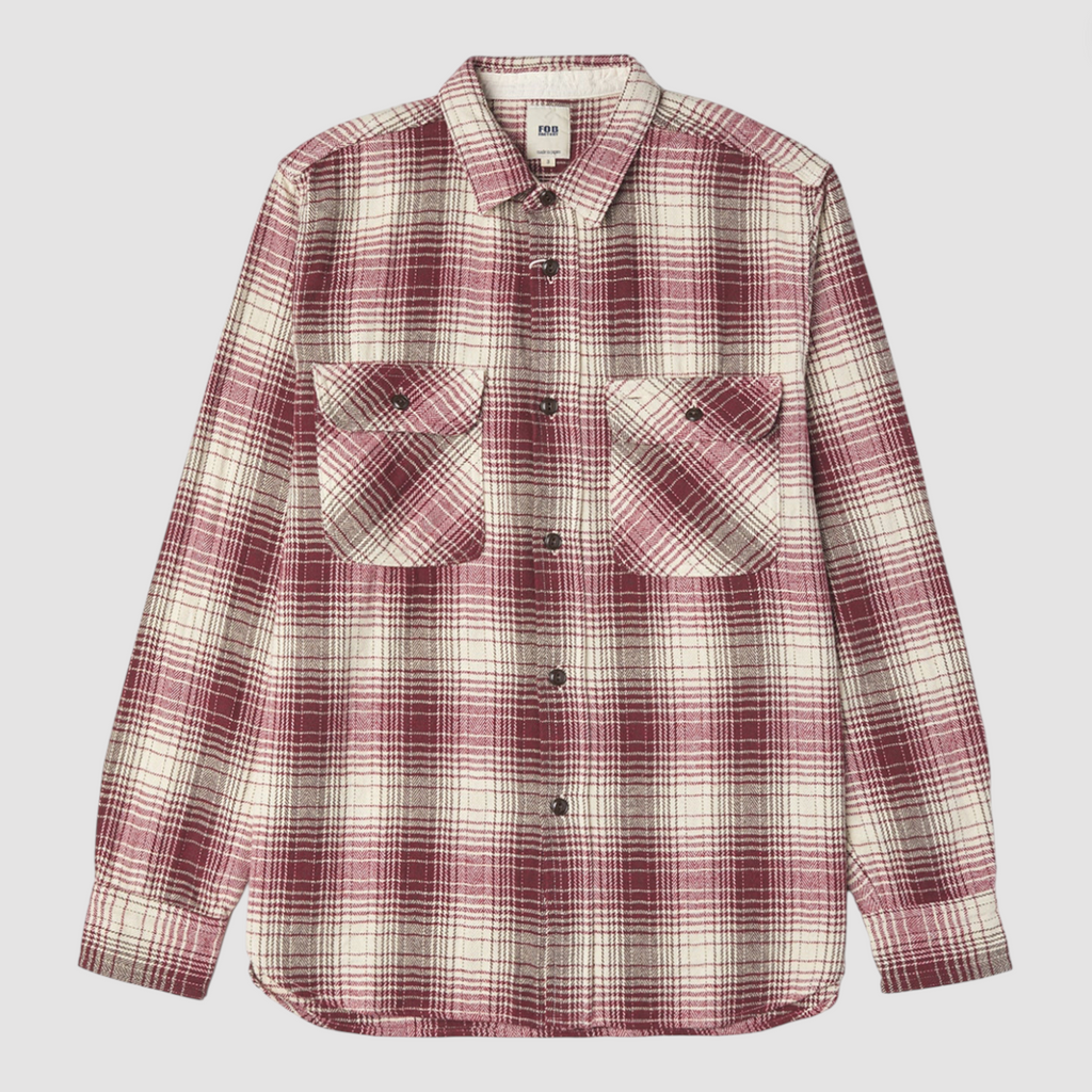 Red and ecru checkered shirt on a light grey background. 