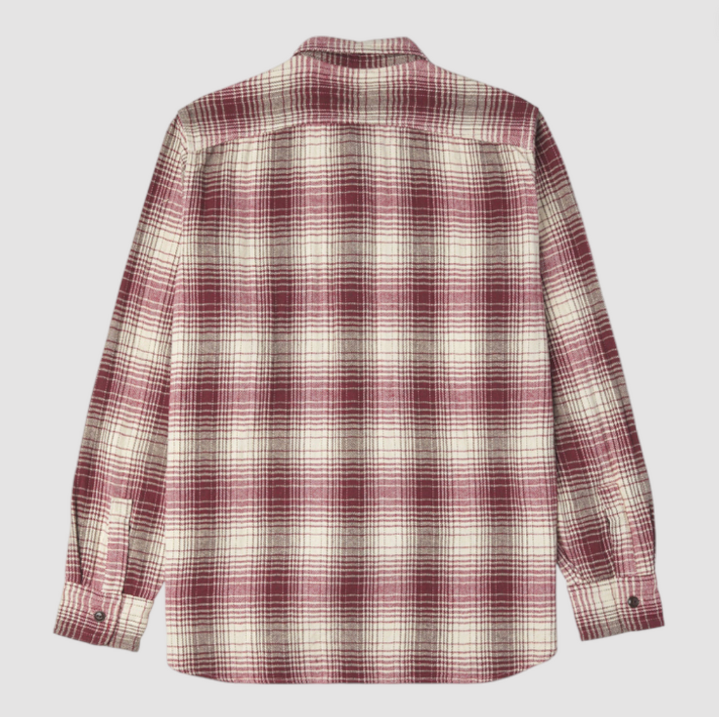 Red and ecru checkered shirt on a light grey background. 