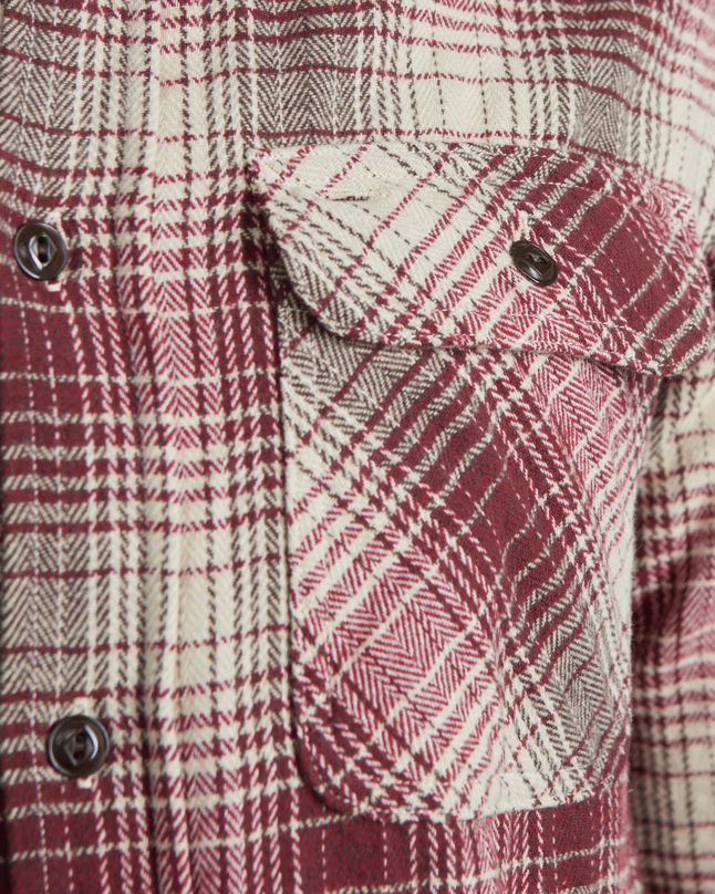 Close up of a red and ecru checkered shirt. 