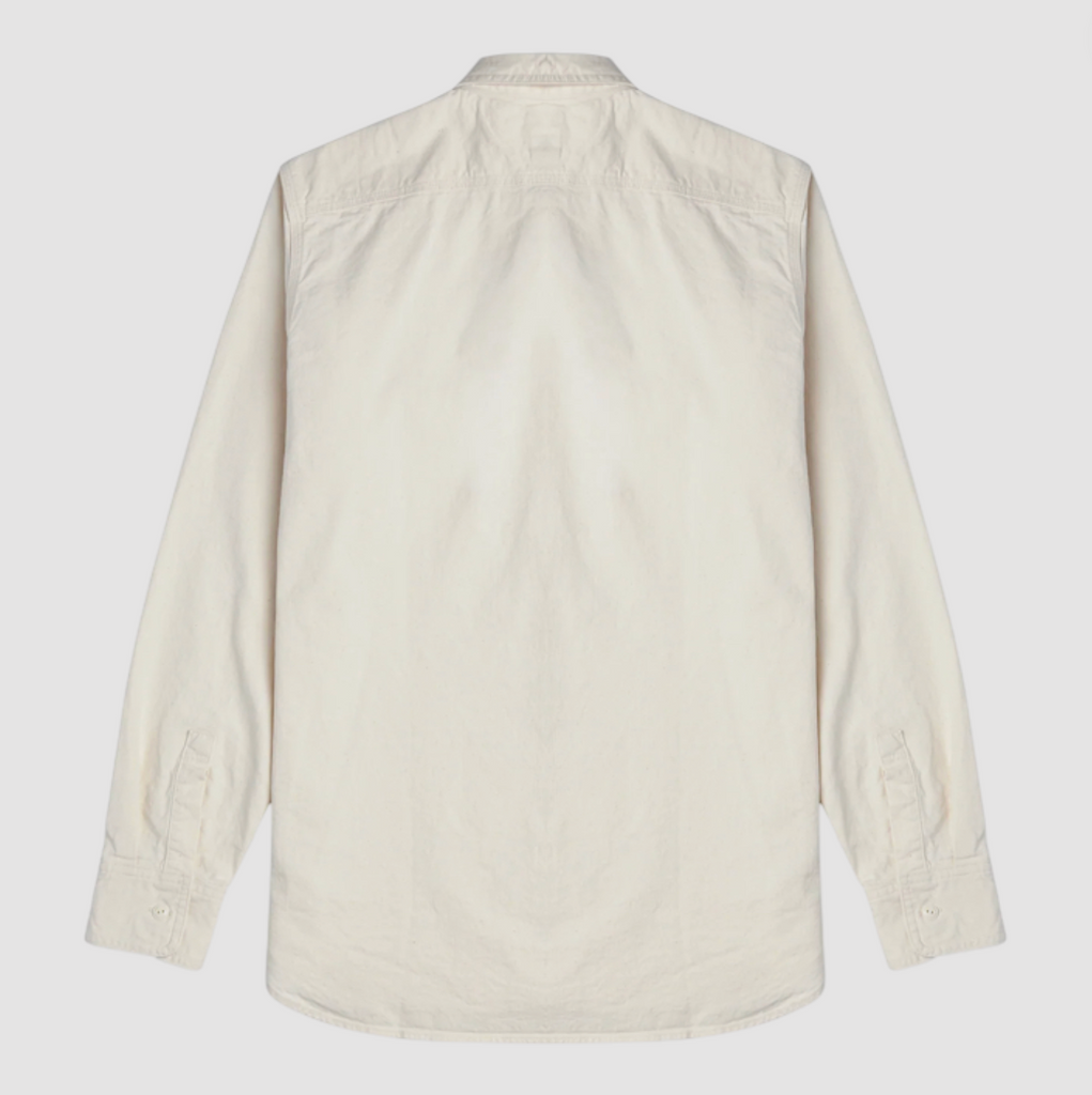 Ecru shirt on a light grey background.