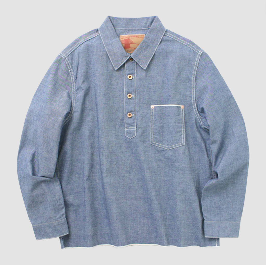 Denim pullover shirt on a light grey background. 