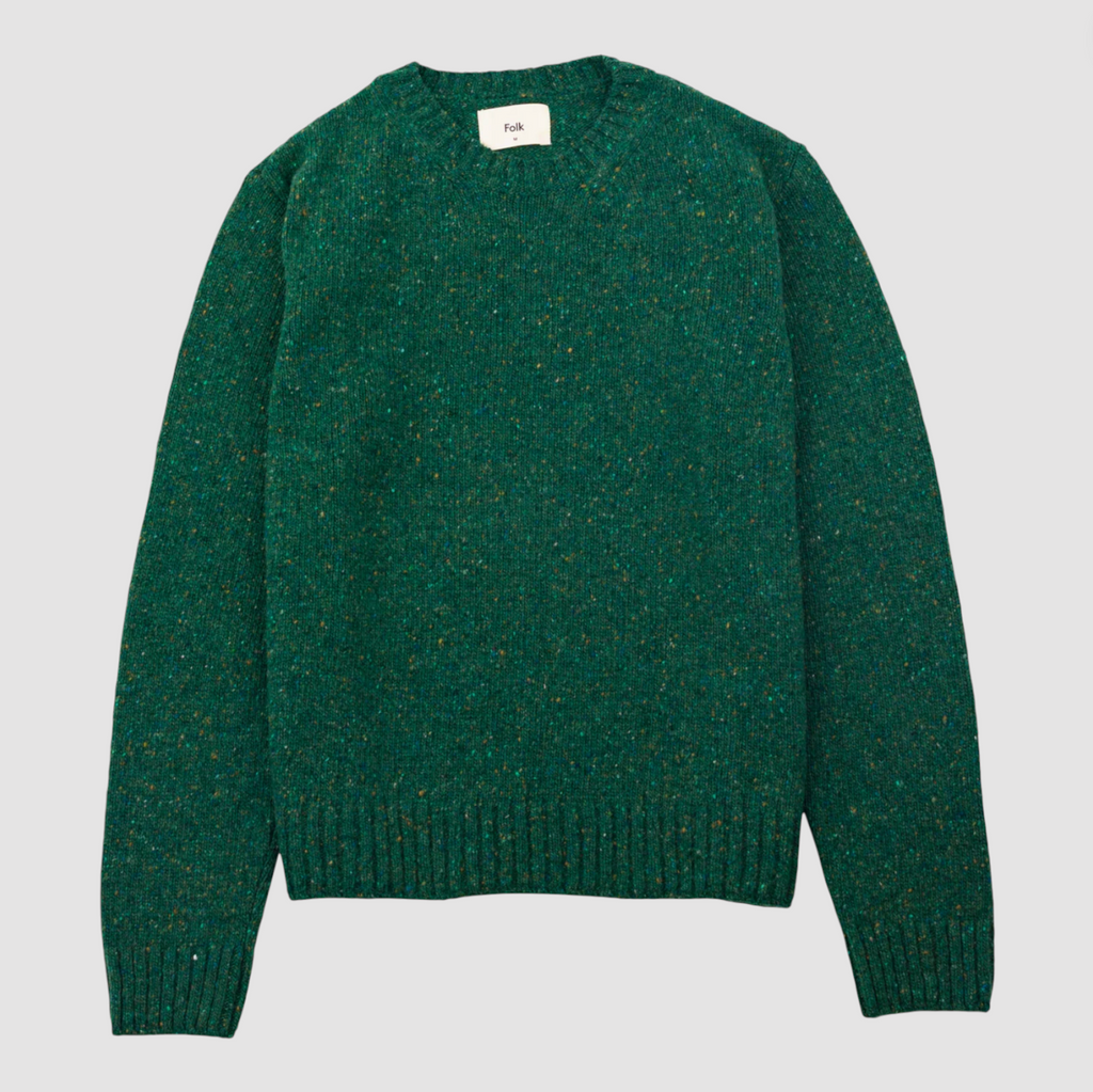 Green sweater on a light gray background.