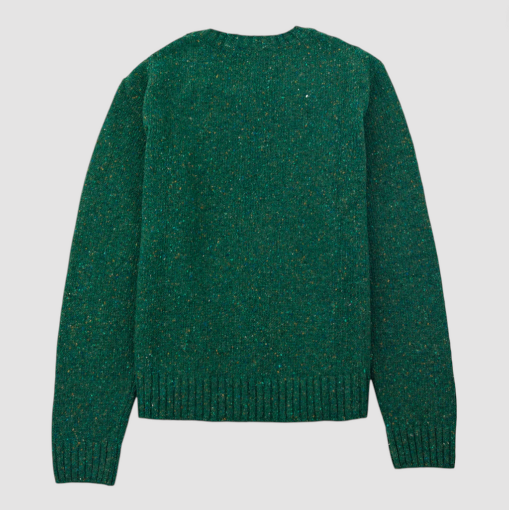 Green sweater on a light gray background.