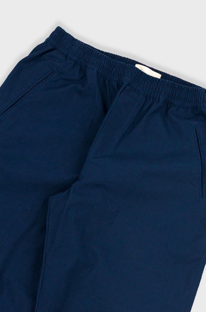 Navy blue pants on a light gray background.