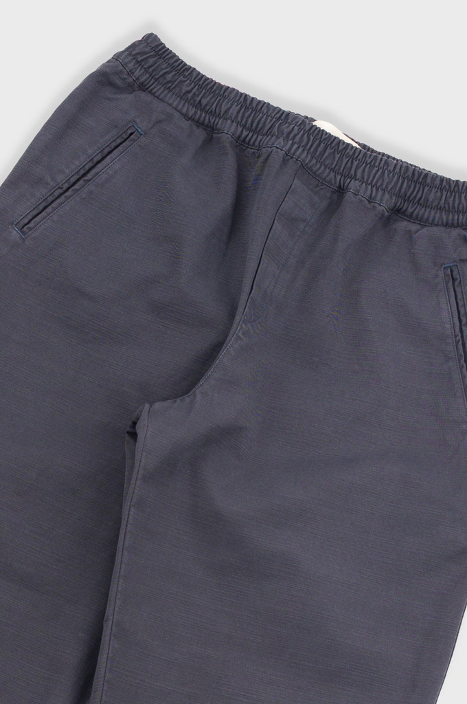 Gray pants with an elastic waistband on a light gray background.