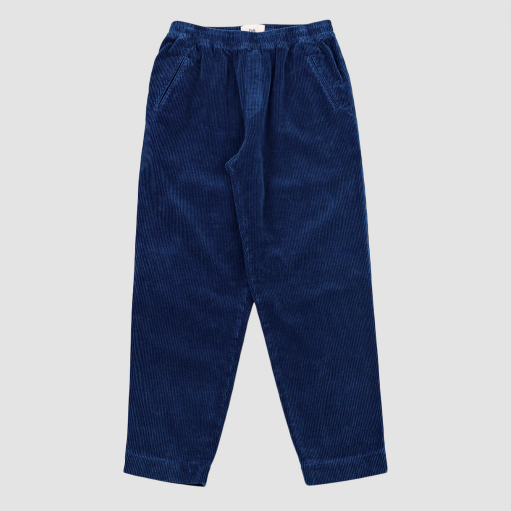 Blue corduroy elasticated waistband pants on a grey background.