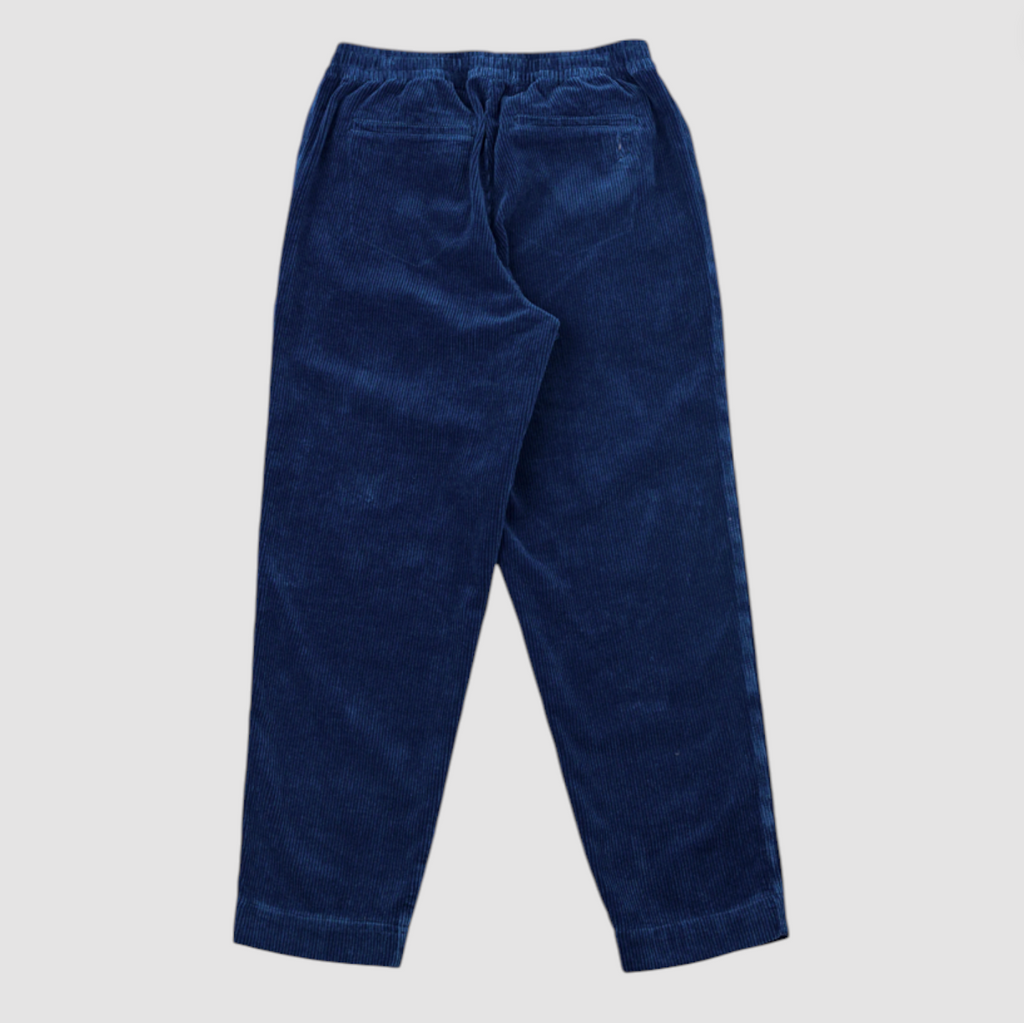 Blue corduroy elasticated waistband pants on a grey background.