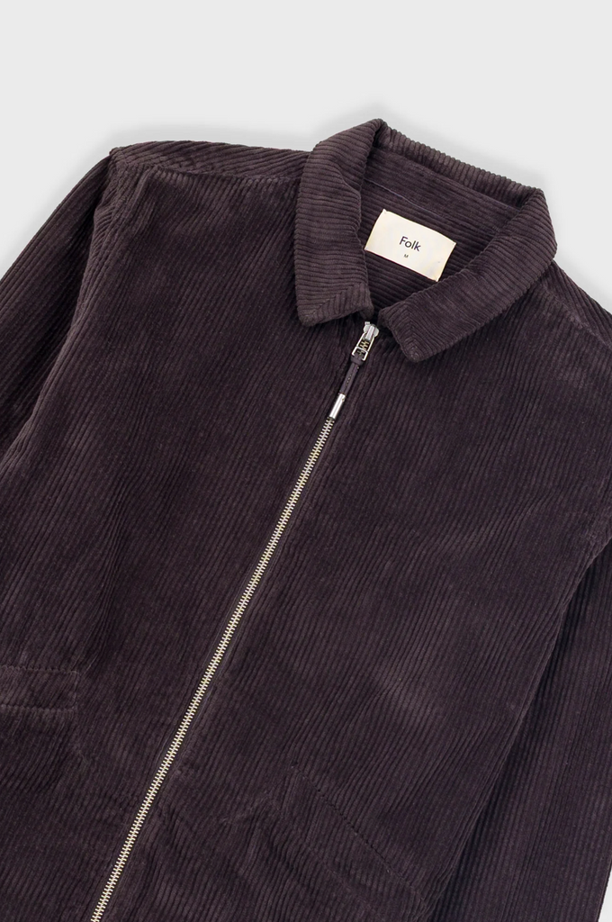Dark brown corduroy jacket with a zipper on a white background.