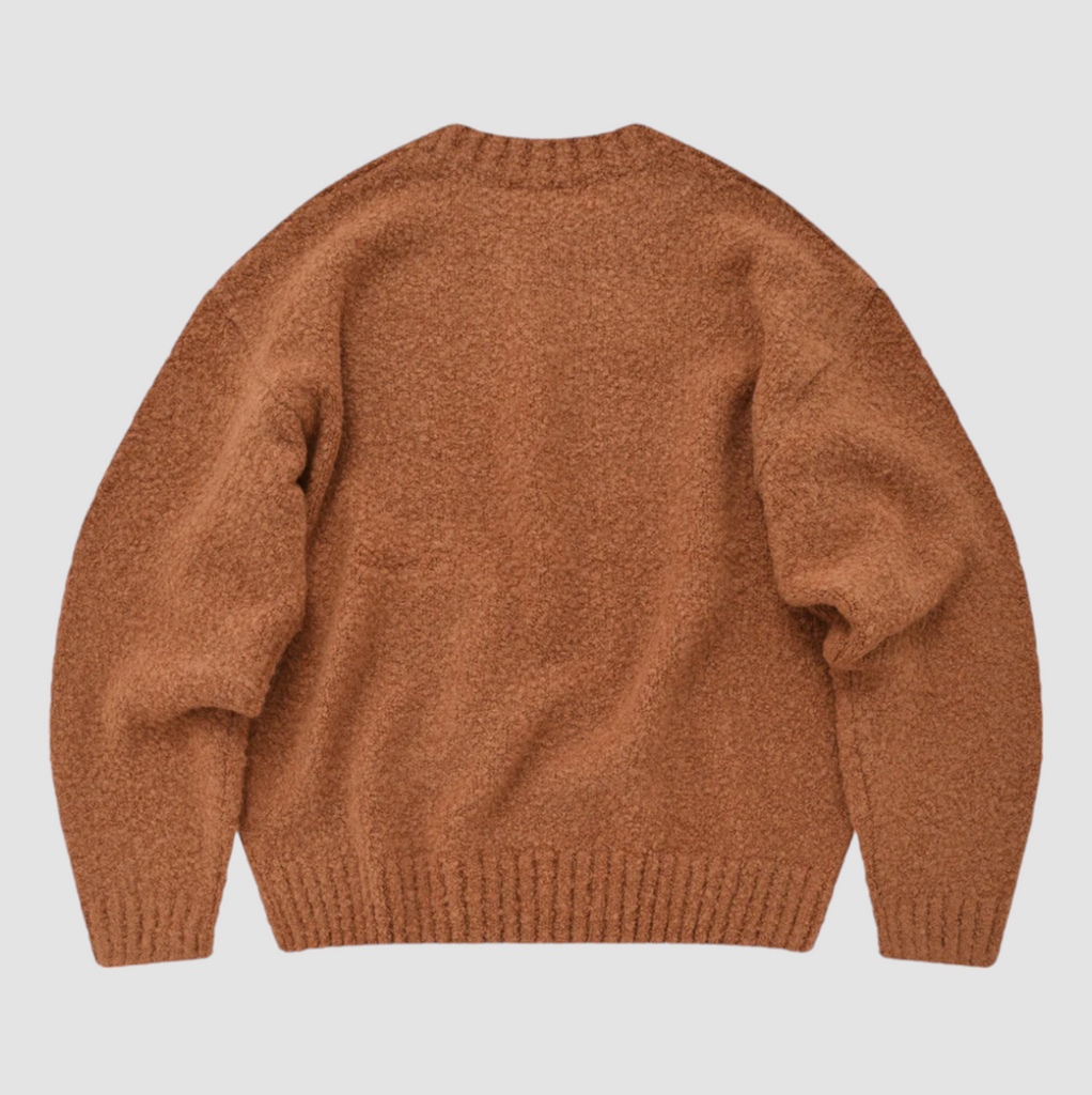 FrizmWorks Alpaca Boucle Knit Sweater in Orange, featuring a soft alpaca-wool blend, large front pocket, and ribbed sleeves and neckline. Made in Korea.