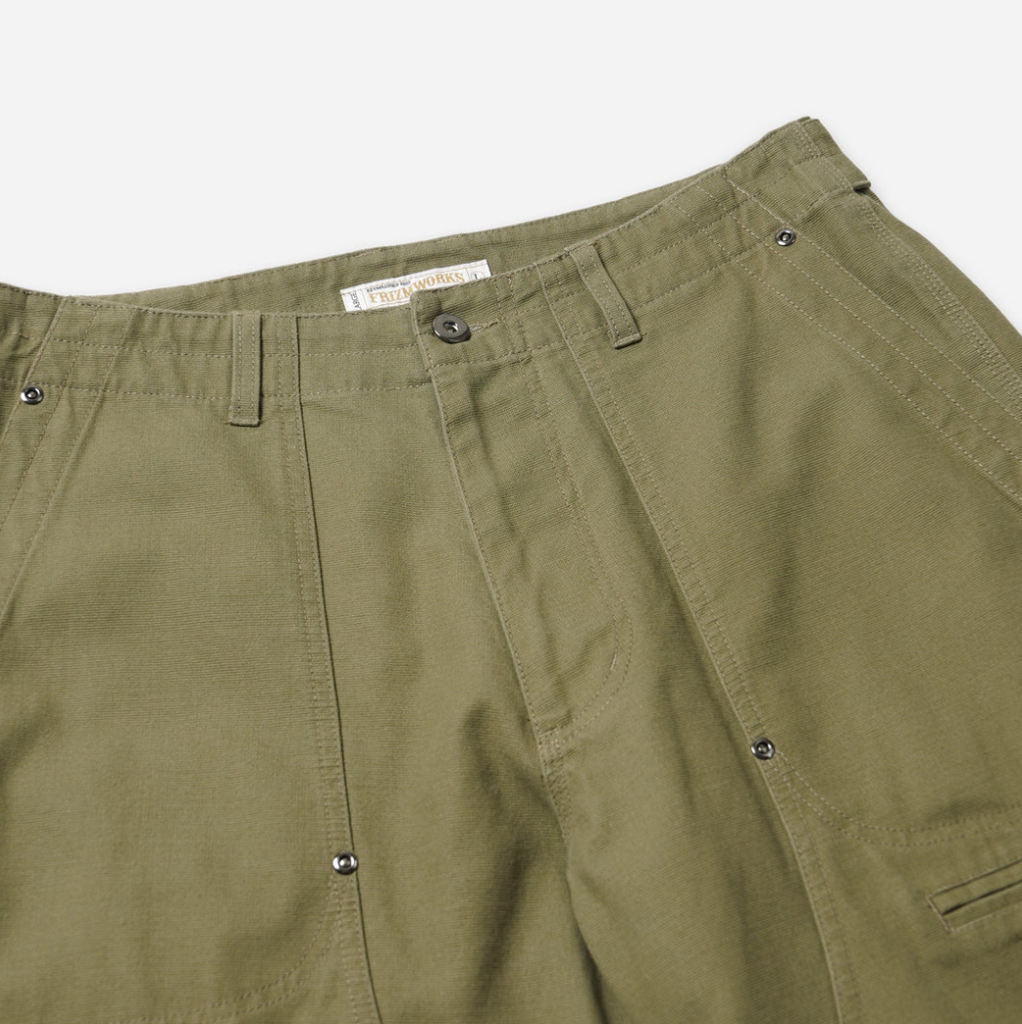 Khaki double knee work pants made from heavy-duty cotton canvas with a vintage wash and wide-leg fit. Includes rear flap pockets and rivet details.