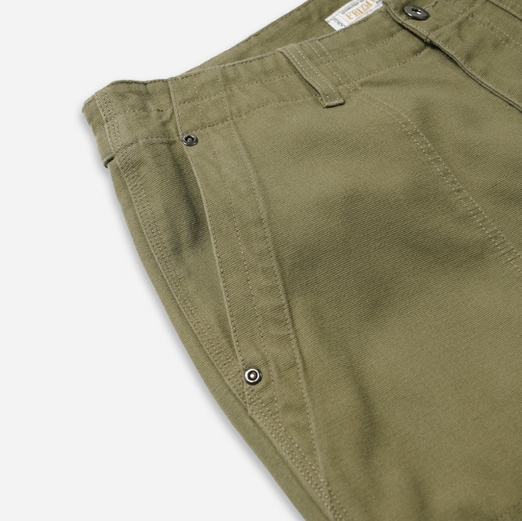 Khaki double knee work pants made from heavy-duty cotton canvas with a vintage wash and wide-leg fit. Includes rear flap pockets and rivet details.