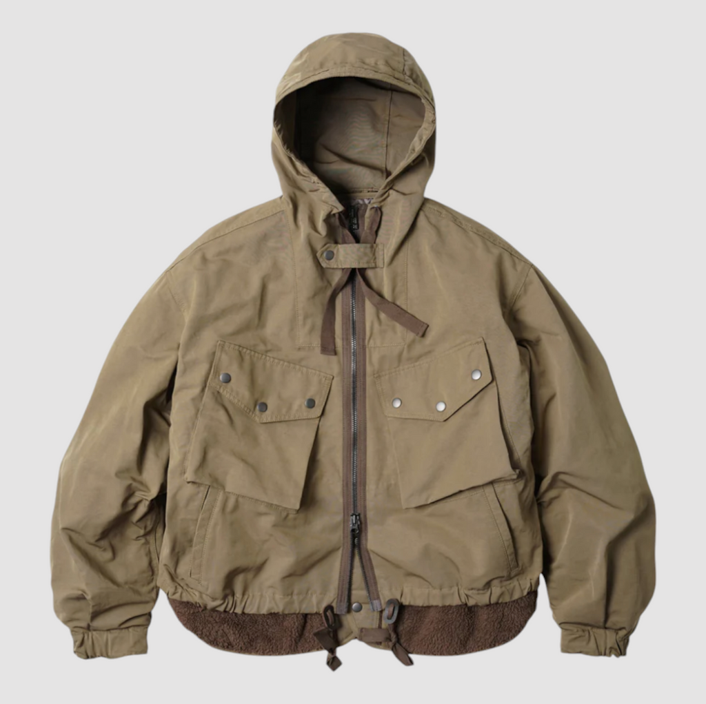 Tan 2-in-1 smock parka with a detachable liner, military bellow pockets, and oversized sleeves for a relaxed fit.