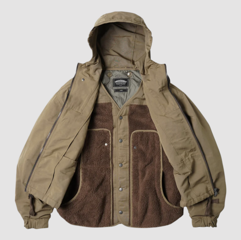 Tan 2-in-1 smock parka with a detachable liner, military bellow pockets, and oversized sleeves for a relaxed fit.