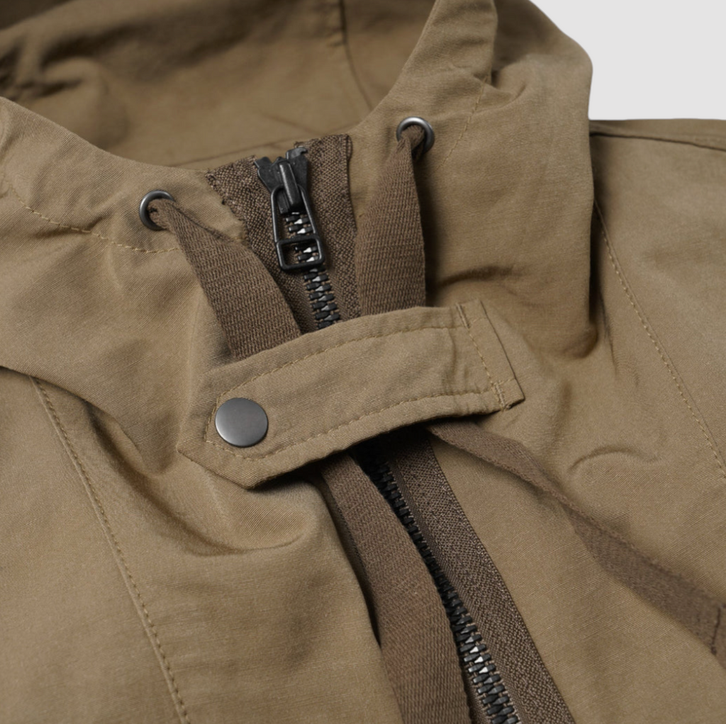 Tan 2-in-1 smock parka with a detachable liner, military bellow pockets, and oversized sleeves for a relaxed fit.