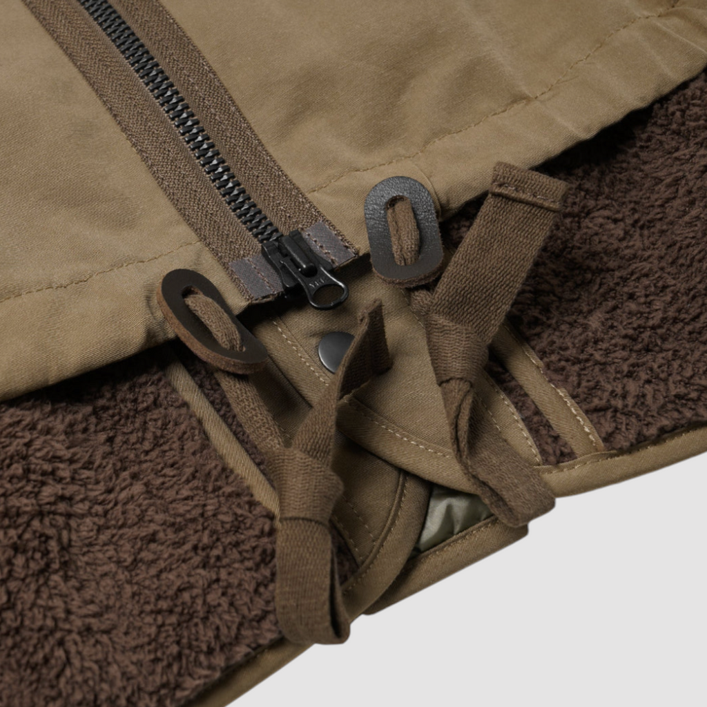 Tan 2-in-1 smock parka with a detachable liner, military bellow pockets, and oversized sleeves for a relaxed fit.