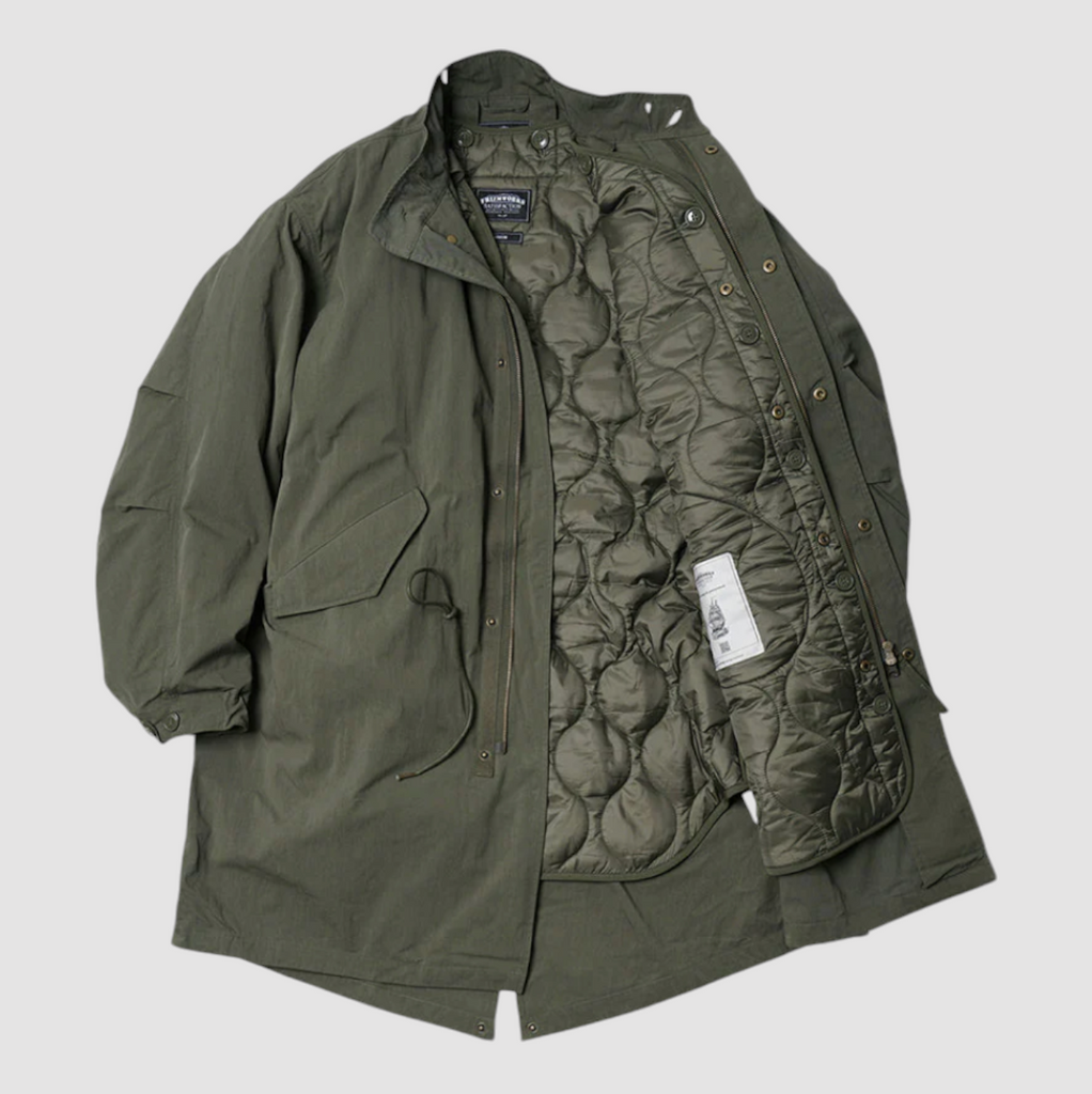 Olive M65 fishtail parka with a heavy cotton twill outer and a detachable ripstop liner. Designed with military-inspired details. Made in Korea.