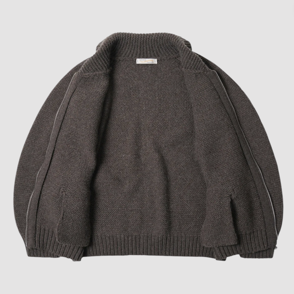 Brown knitted zip up sweater on a light gray background