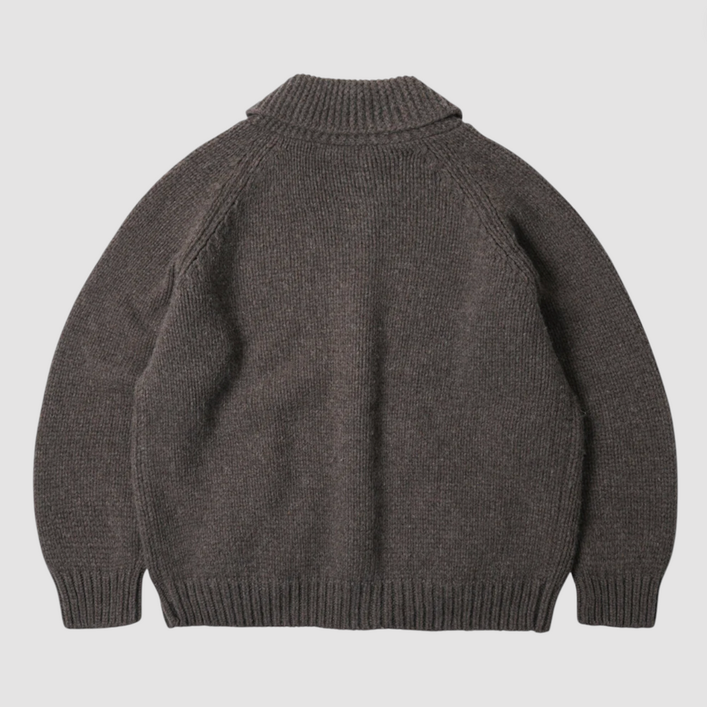 Brown knitted zip up sweater on a light gray background.