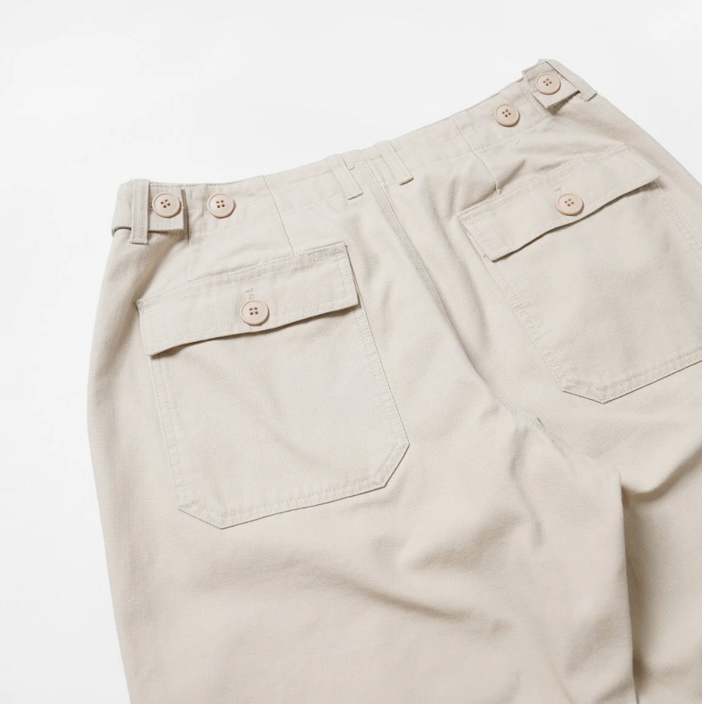 Beige pants with two back pockets on a white background.