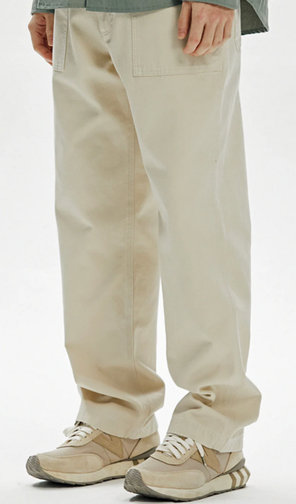 Beige pants worn by a person on a white background.
