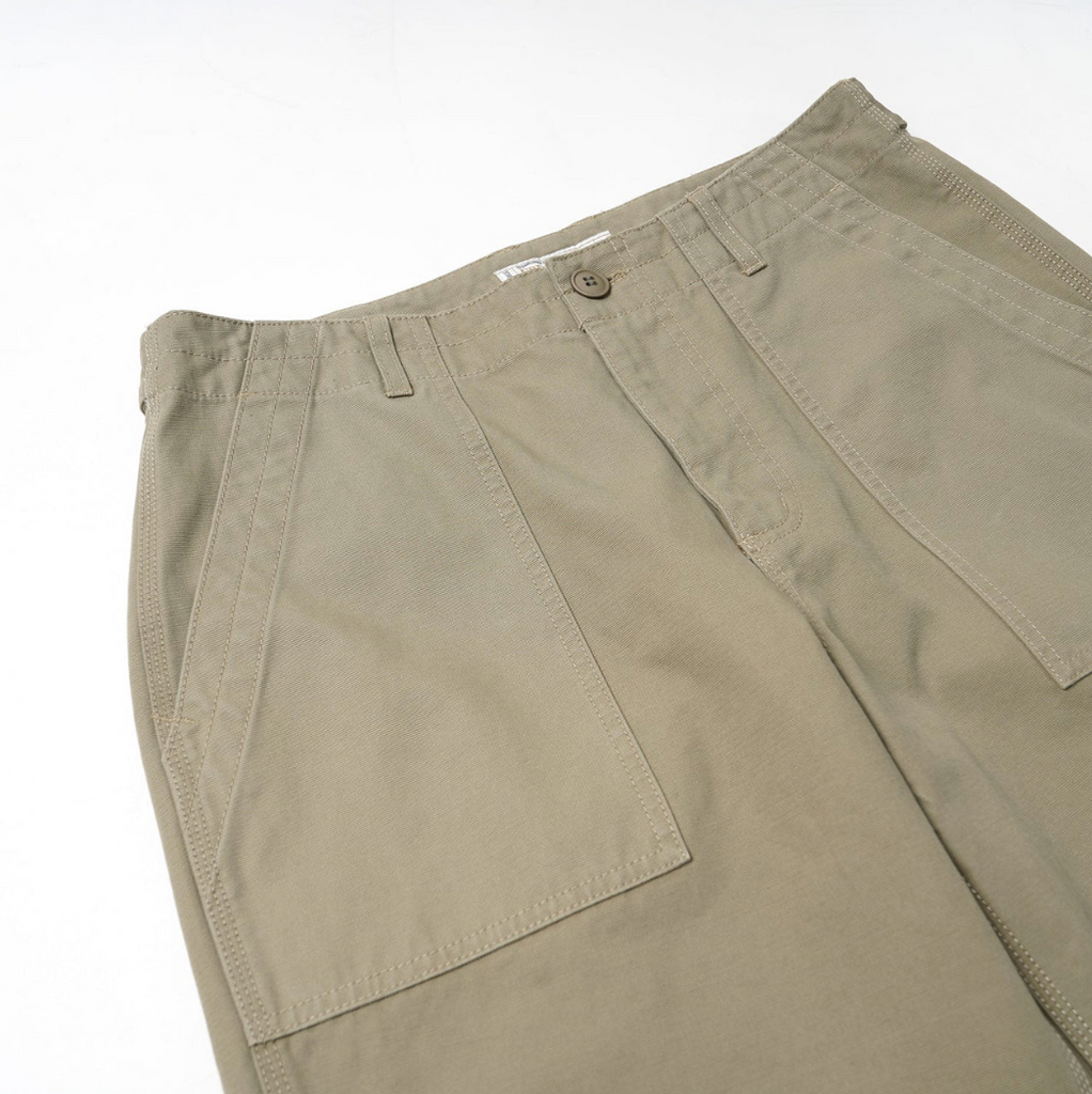 Beige pants with a white background.
