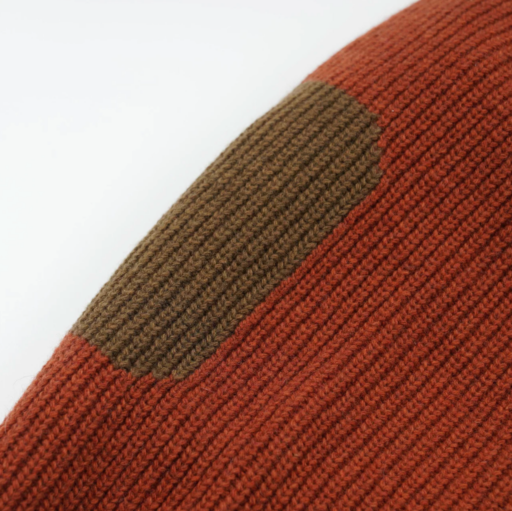 Close-up of an orange and green knitted fabric.