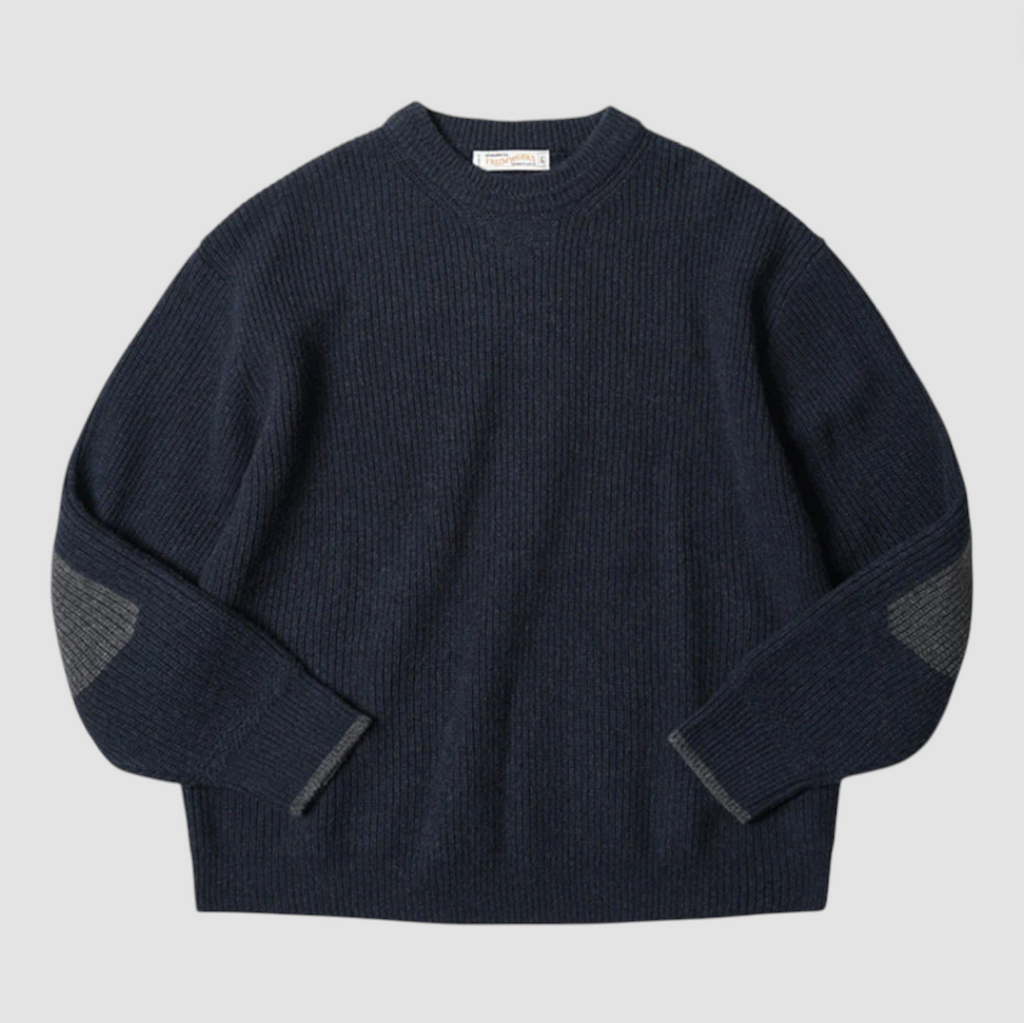 Navy blue sweater with gray elbow patches on a light gray background.