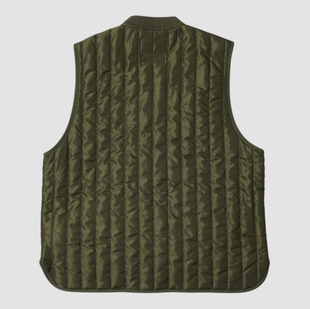 Green quilted vest on a light gray background.