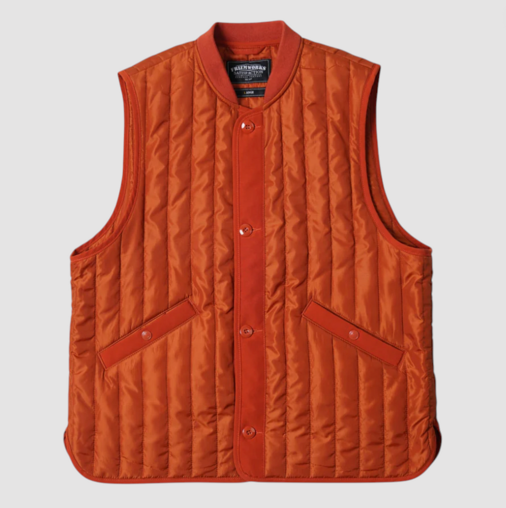 Orange quilted vest with button details on a light gray background.