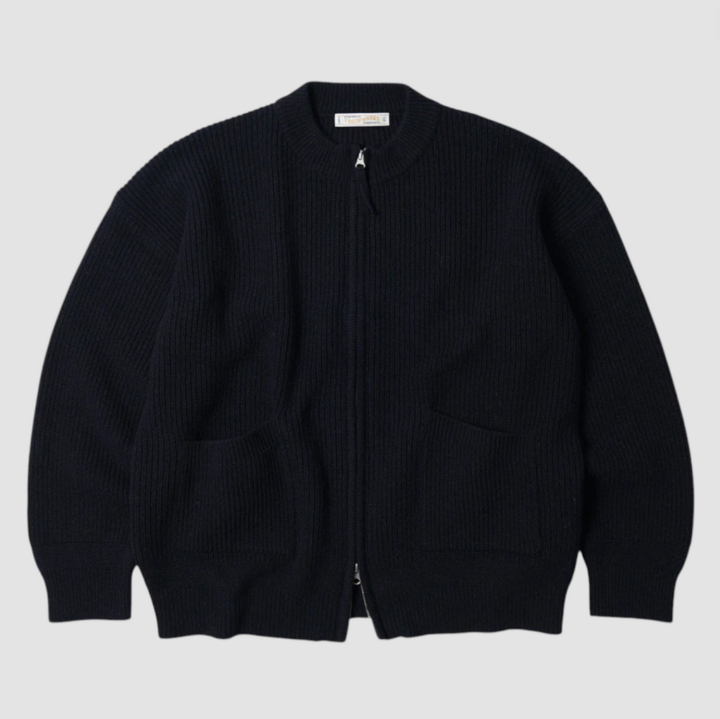 Navy zip-up sweater on a light gray background.